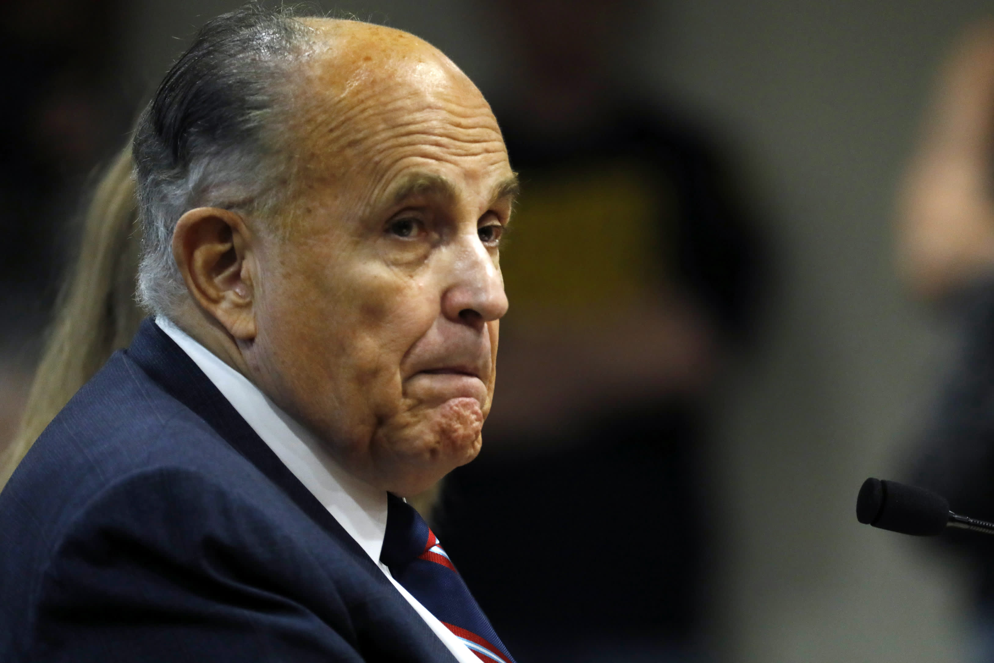 In this Dec. 2, 2020, file photo, Rudy Giuliani, personal lawyer of US President Donald Trump, looks on during an appearance before the Michigan House Oversight Committee in Lansing, Michigan.