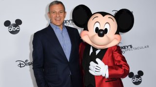 Bob Iger poses with Mickey Mouse