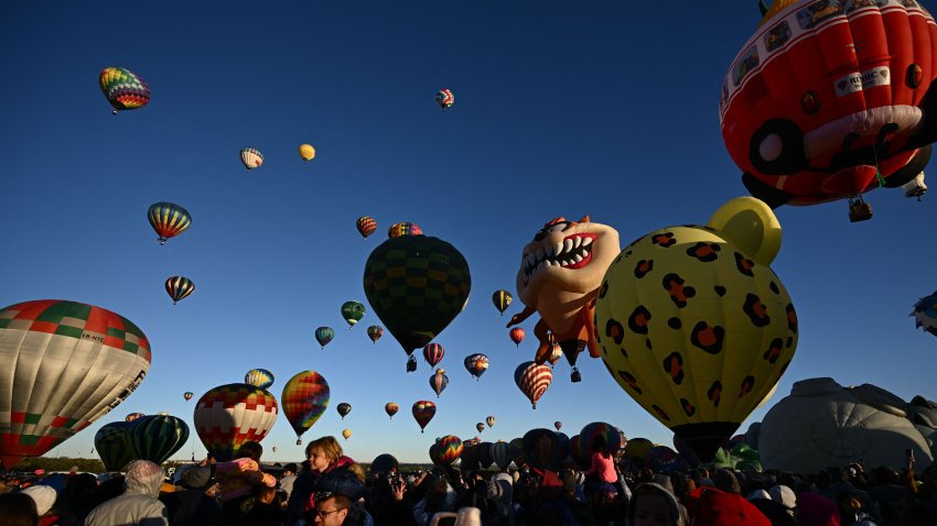 Hot air balloons take flight at sunrise during the Albuquerque International Balloon Fiesta in Albuquerque, New Mexico on October 13, 2023. (Photo by Patrick T. Fallon / AFP) (Photo by PATRICK T. FALLON/AFP via Getty Images)