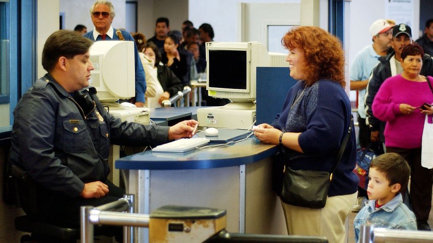 SAN YSIDRO, CA – FEBRUARY 20:  An Immigration and Naturalization Service (INS) inspector screens people walking into the United States from Mexico at the San Ysidro Port of Entry February 20, 2003 in San Ysidro, California. The San Ysidro border crossing is the world’s busiest. On March 1, INS will merge with the U.S. Customs Service under the Homeland Security Office as directed by the White House in an effort to beef up border security.  (Photo by David McNew/Getty Images)