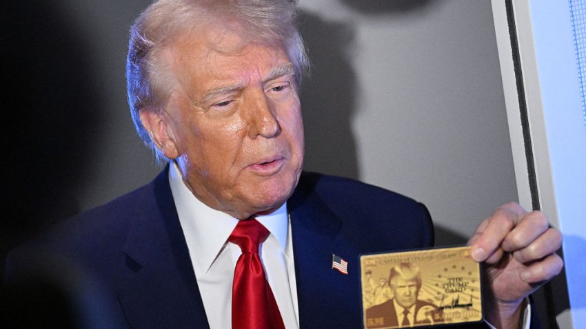 US President Donald Trump holds the $5 million dollar Gold Card as he speaks to reporters while in flight on board Air Force One, en route to Miami, Florida on April 3, 2025. Trump is travelling to the Trump National Doral Golf Club before going to his Mar-a-Lago Resort. (Photo by MANDEL NGAN / AFP) (Photo by MANDEL NGAN/AFP via Getty Images)