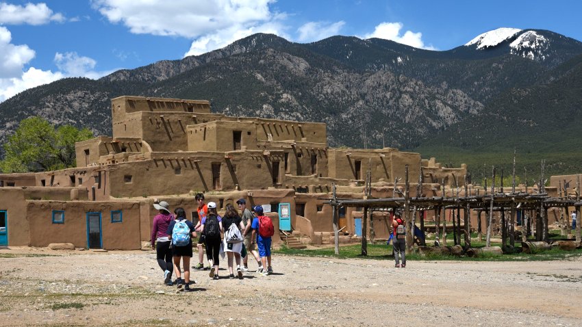 TAOS, NEW MEXICO – MAY 15, 2019: A group of high school students tour Taos Pueblo in Taos, New Mexico. The pueblo’s multi-story adobe residential complex has been home to Native-Americans for more than one thousand years. The ancient pueblo, built between 1000 and 1450, is considered to be one of the oldest continuously inhabited communities in the United States. (Photo by Robert Alexander/Getty Images)