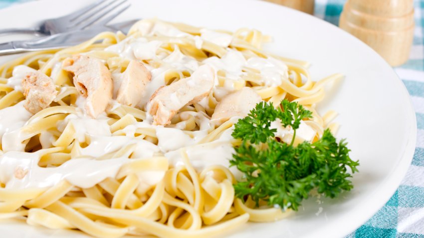 Chicken Fettuccine Alfredo with olive oil in a bottle