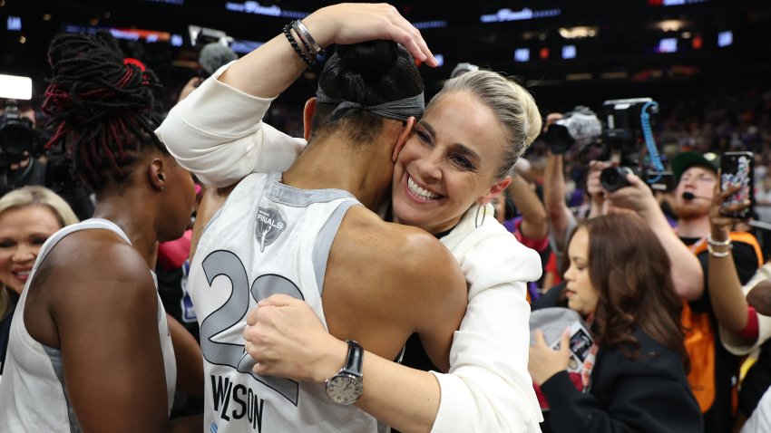 PHOENIX, ARIZONA – OCTOBER 10: A’ja Wilson #22 of the Las Vegas Aces celebrates with head coach Becky Hammon after winning game four of the 2025 WNBA Playoffs finals at Mortgage Matchup Center on October 10, 2025 in Phoenix, Arizona. The Las Vegas Aces defeat the Phoenix Mercury 97-86 to win the championship. NOTE TO USER: User expressly acknowledges and agrees that, by downloading and or using this photograph, User is consenting to the terms and conditions of the Getty Images License Agreement.  (Photo by Christian Petersen/Getty Images)