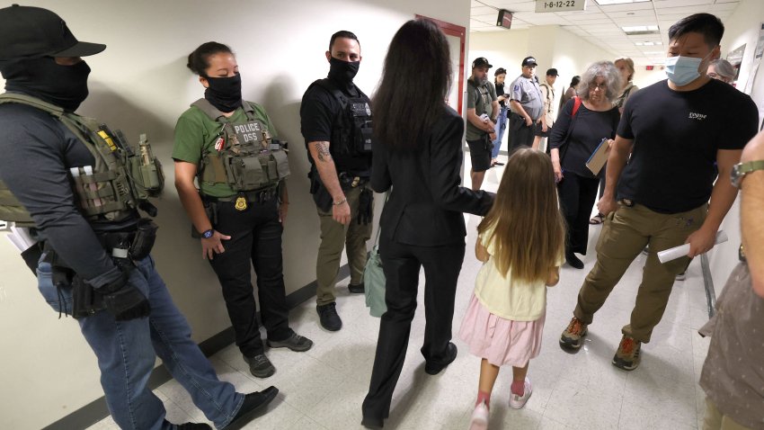 Federal agent wait in the hallway outside of a courtroom at New York Federal Plaza Immigration Court at the Jacob K. Javitz Federal Building on August 5, 2025 in New York City. US President Donald Trump has made deporting undocumented immigrants a key priority for his second term, after successfully campaigning against an alleged &quot;invasion&quot; by criminals. (Photo by TIMOTHY A. CLARY / AFP) (Photo by TIMOTHY A. CLARY/AFP via Getty Images)