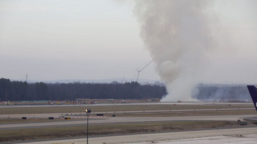 Smoke seen at Dulles International Airport after a plane engine failed during a United flight&#8217;s takeoff en route to Tokyo, Japan on Dec. 13, 2025. The engine failure sparked a brush fire near the runway.