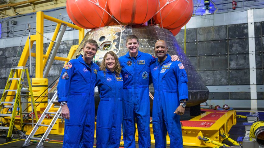 NASA astronauts Reid Wiseman, commander; left, Christina Koch, mission specialist; CSA (Canadian Space Agency) astronaut Jeremy Hansen, mission specialist; and NASA astronaut Victor Glover, Artemis II pilot, right, pose for a group photo after viewing the Orion spacecraft in the well deck of USS John P. Murtha, Saturday, April 11, 2026, in the Pacific Ocean off the coast of California.