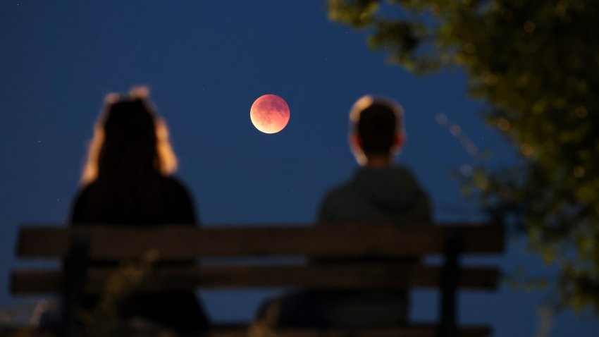 Onlookers watch the total lunar eclipse