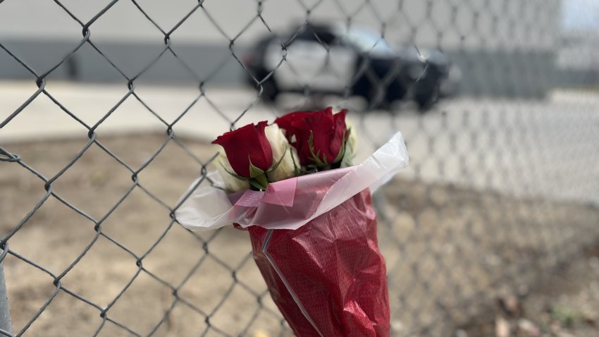A bouquet of roses is seen on Wednesday, Sept. 16, 2026, at the entrance to the site of the NBC4 helicopter crash in Chatsworth.
